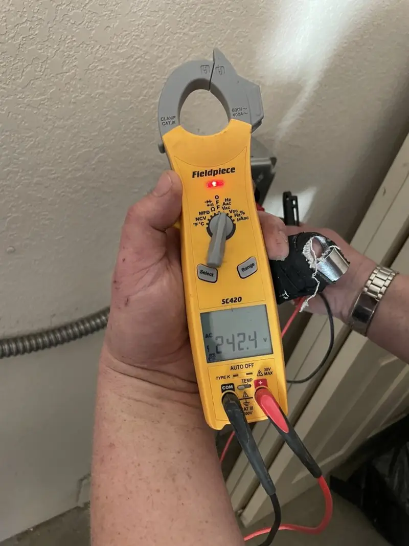 Voltage testing with clamp meter during Recessed Lighting Installation in Cicero
